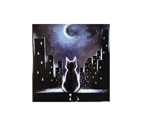 Magnet of a cat sitting on a rooftop at night, looking at a crescent moon above a glowing city skyline.