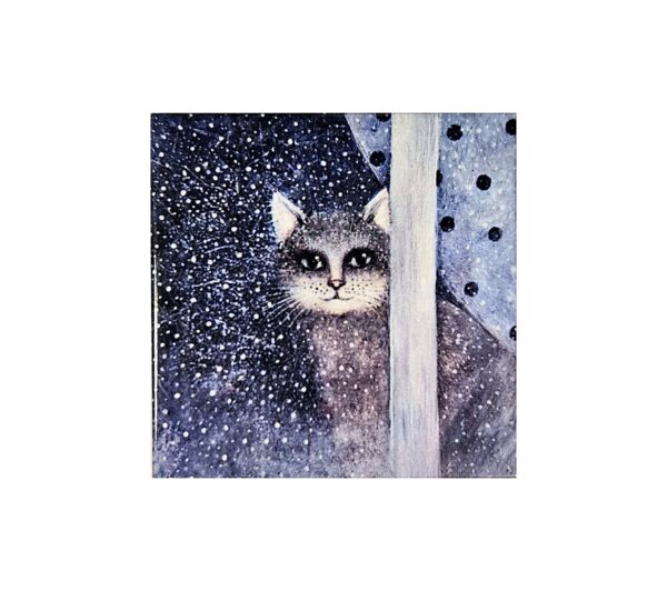 Magnet showing a grey cat sitting behind a window with snow falling outside and polka dot curtains on the sides.