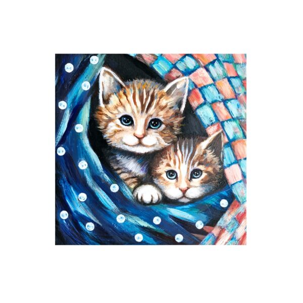 Magnet showing two ginger kittens peeking out from under a colorful, patterned blanket with polka dots.
