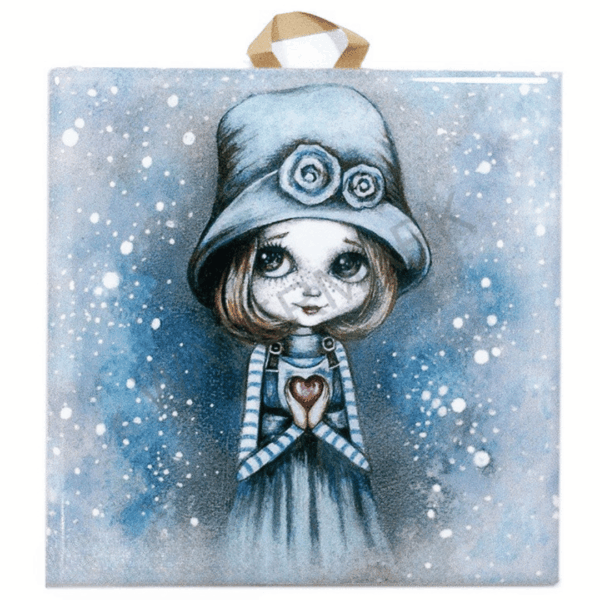 Ceramic tile painting of a girl in a blue hat and striped sleeves holding a red heart, with snowy background and cork backing for safe hanging.