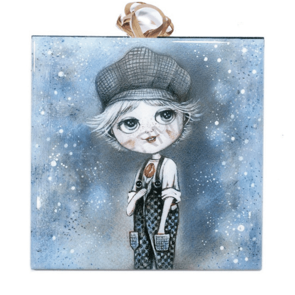 Ceramic tile painting of a boy in a cap and overalls holding a red tulip, with a snowy blue background and cork backing for safe wall hanging.