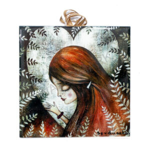 Ceramic tile featuring a girl with long auburn hair and closed eyes, leaning against a large glowing heart framed by leafy branches.