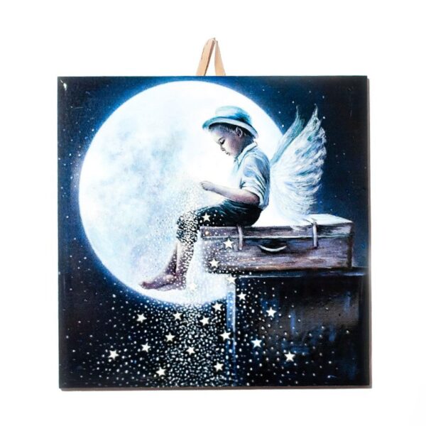 Ceramic tile with artwork of a boy angel sitting on a suitcase in front of a large moon, sprinkling stars into the night sky.