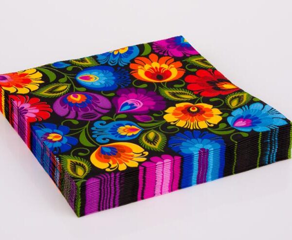 Stack of colorful floral patterned paper napkins with bright multicolor flowers on a black background